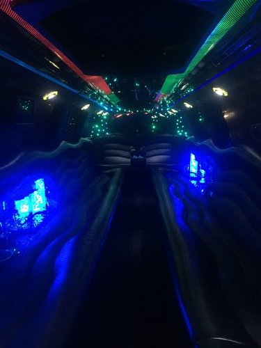 Interior picture of stretch Cadillac Escalade showing off a dazzling lighting display