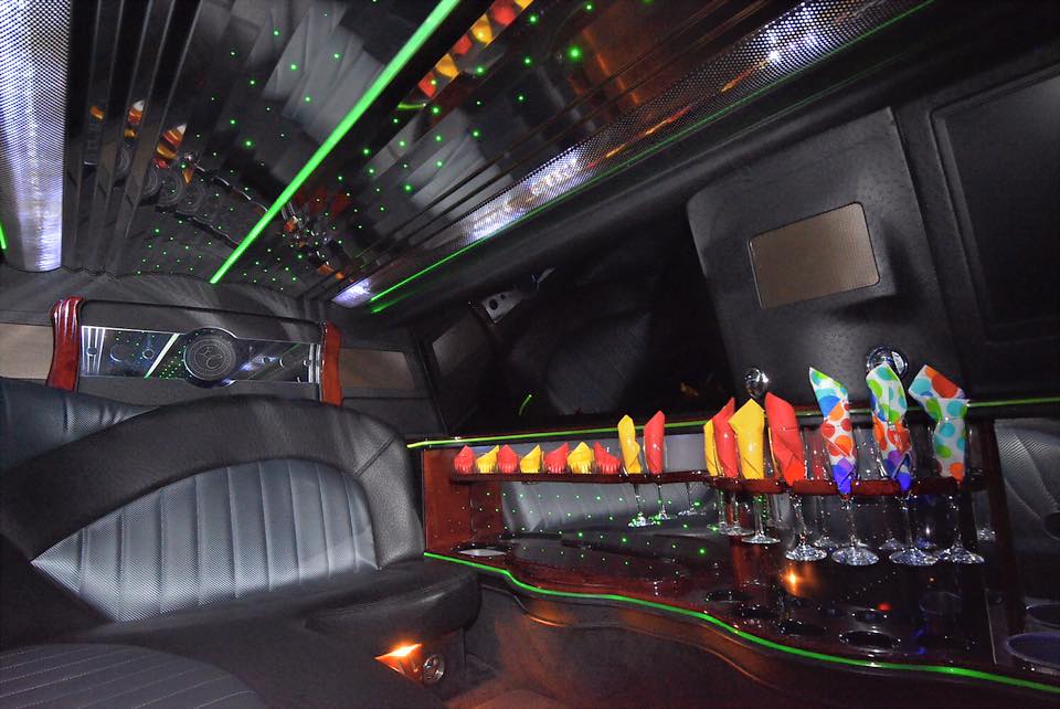 Interior picture of stretch 10 passenger Lincoln Towncar ready for a birthday party complete with champagne flutes and napkins and a stocked bar